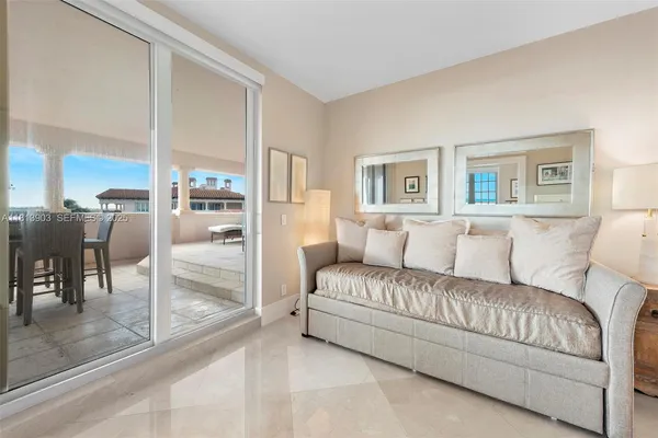 a living room with furniture and a glass door