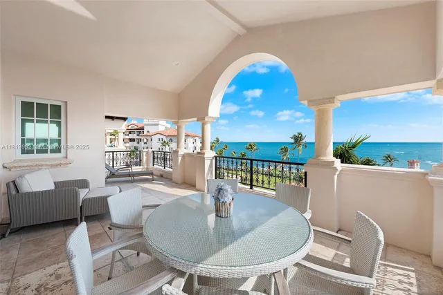 a view of a chairs and tables in the balcony