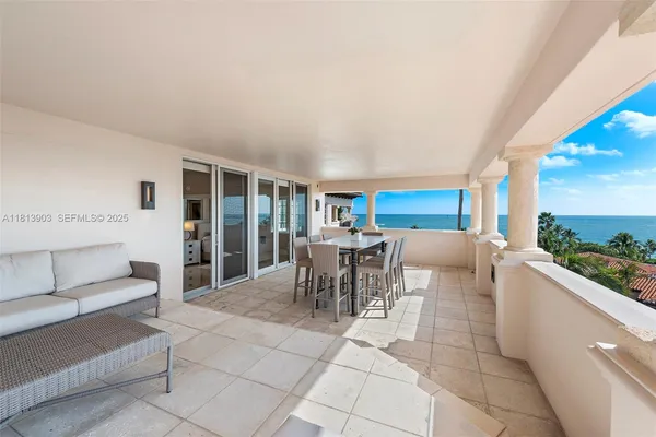 a living room with furniture a dining table and a potted plant