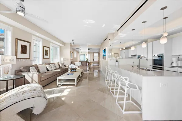 a living room with furniture kitchen and a table