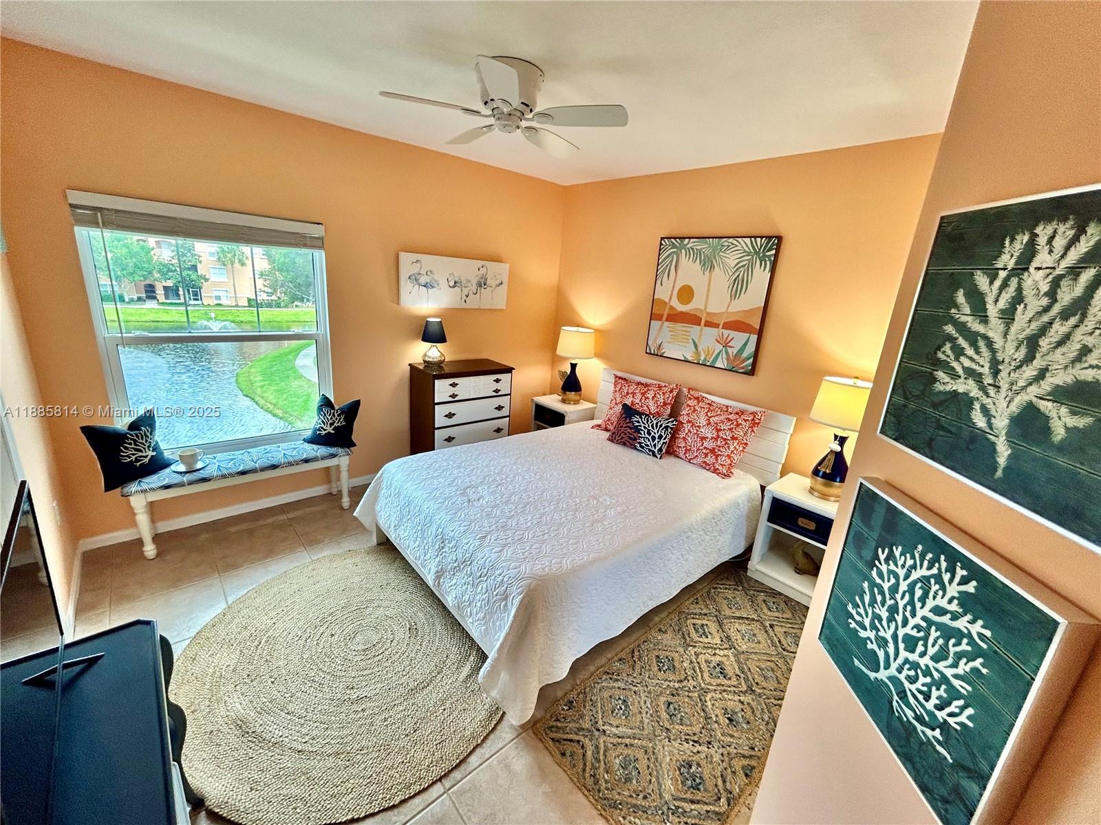 5080 Fairways Circle, Unit 307 Vero Beach, FL 32967 - Photo 12 of 27 a bedroom with a bed a dresser with wooden floor