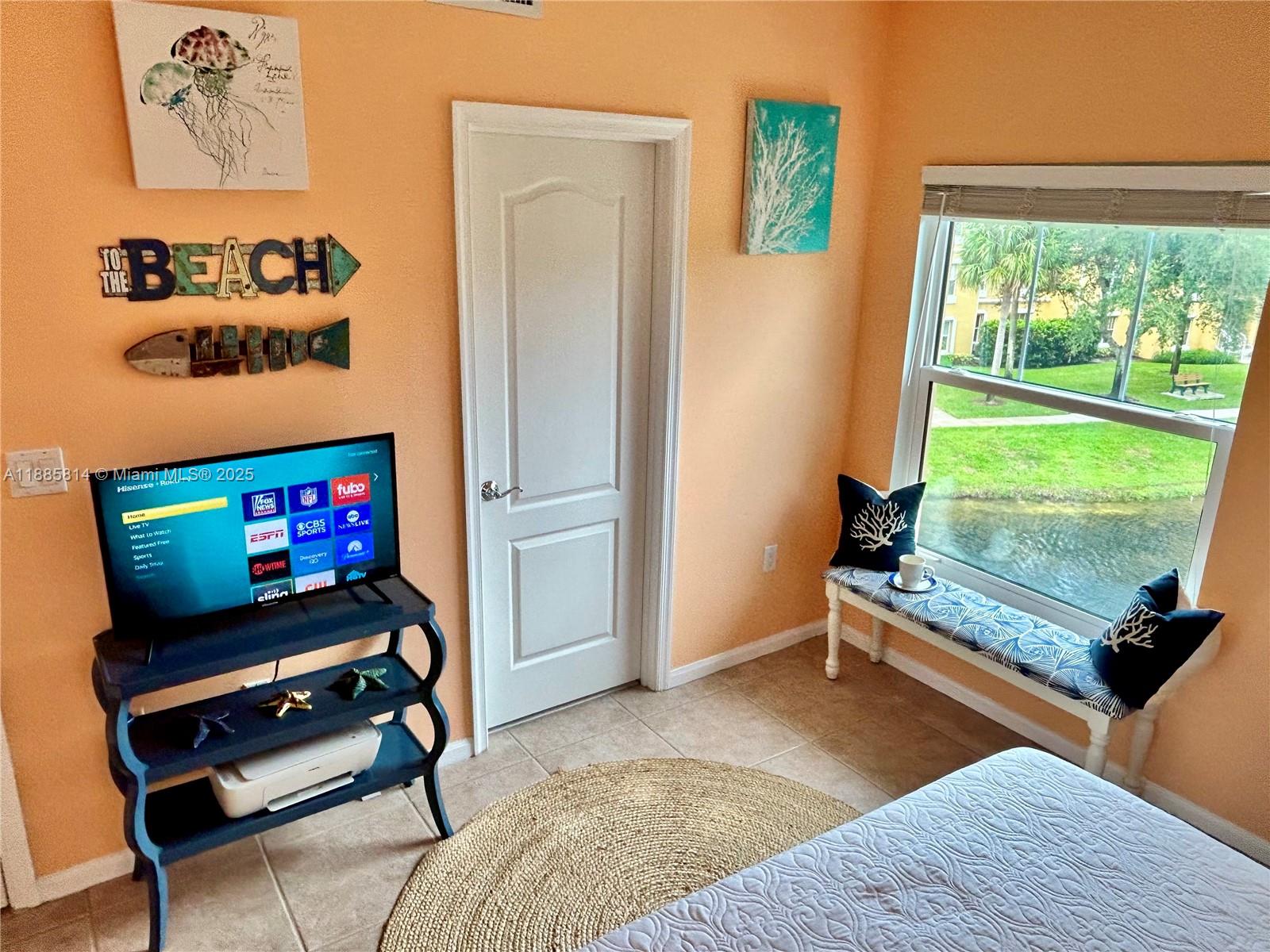 5080 Fairways Circle, Unit 307 Vero Beach, FL 32967 - Photo 13 of 27 a living room with furniture rug and a window