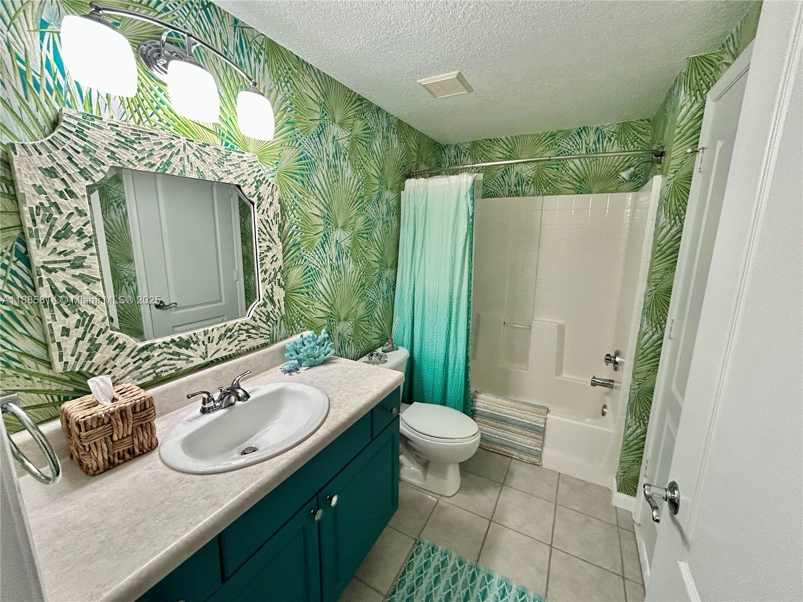 5080 Fairways Circle, Unit 307 Vero Beach, FL 32967 - Photo 14 of 27 a bathroom with a granite countertop sink and a mirror