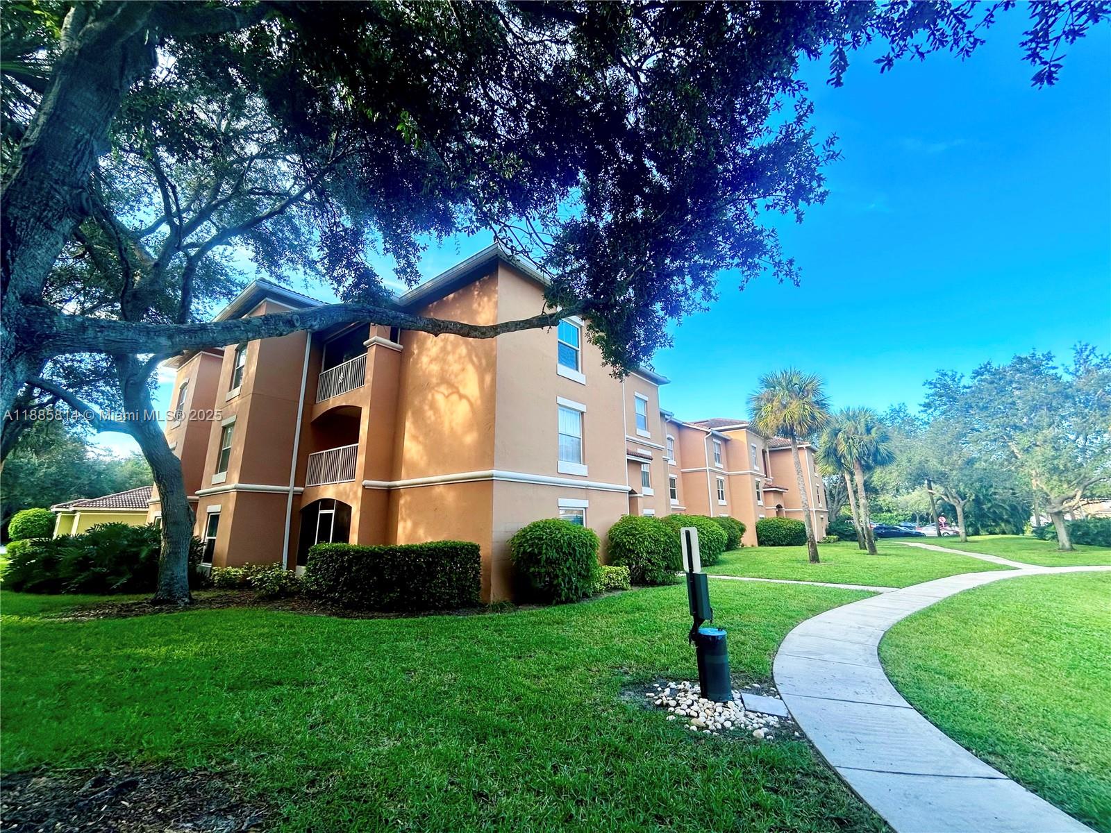 5080 Fairways Circle, Unit 307 Vero Beach, FL 32967 - Photo 2 of 27 a view of a house with a yard