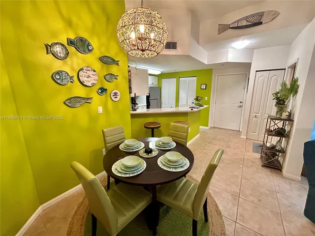 a view of a dining room with furniture and chandelier