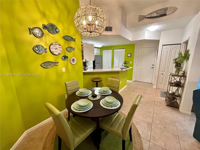 a view of a dining room with furniture and chandelier