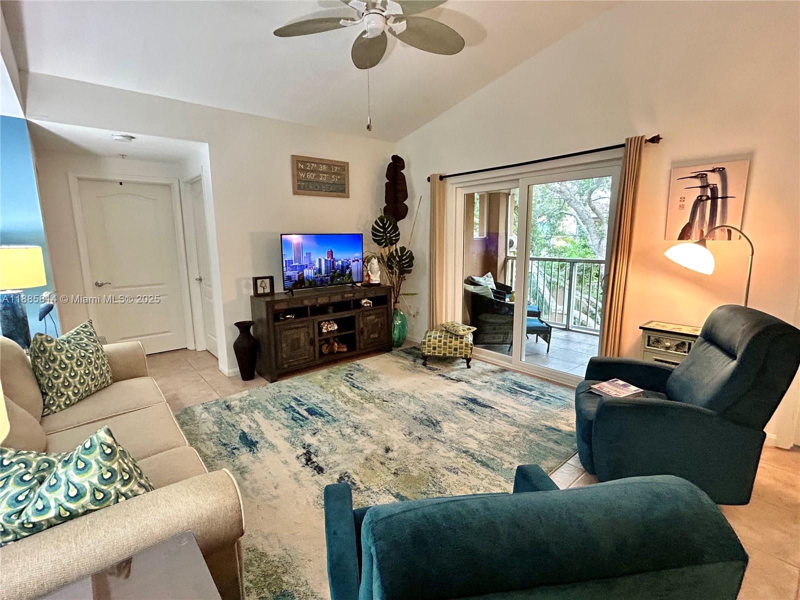 5080 Fairways Circle, Unit 307 Vero Beach, FL 32967 - Photo 8 of 27 a living room with furniture and a flat screen tv