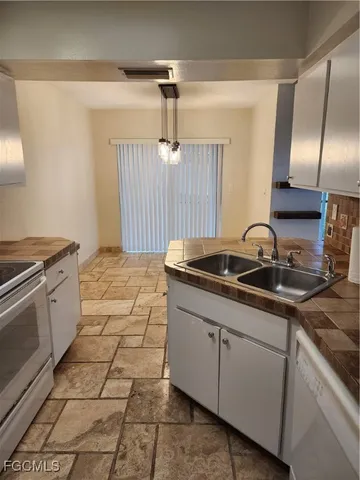 a kitchen that has a sink and a stove