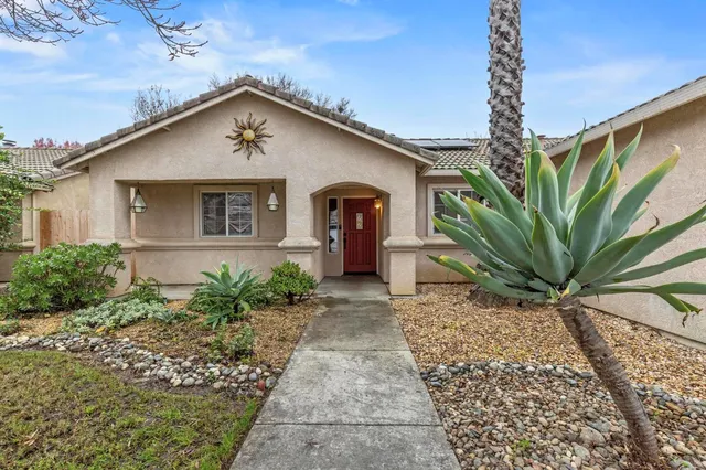 a front view of a house with garden