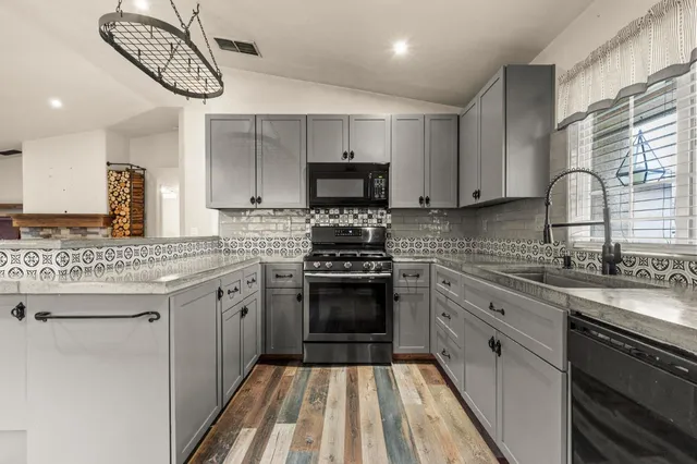 a kitchen with a sink stove and cabinets