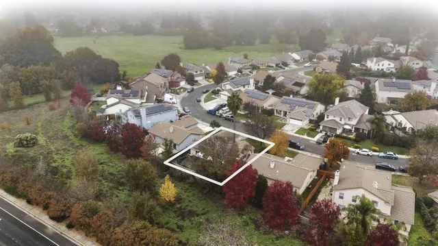 an aerial view of a house with outdoor space and lake view