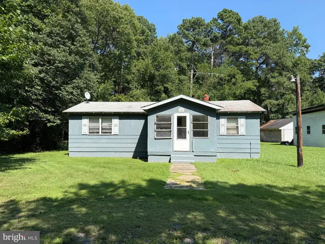 a front view of a house with yard