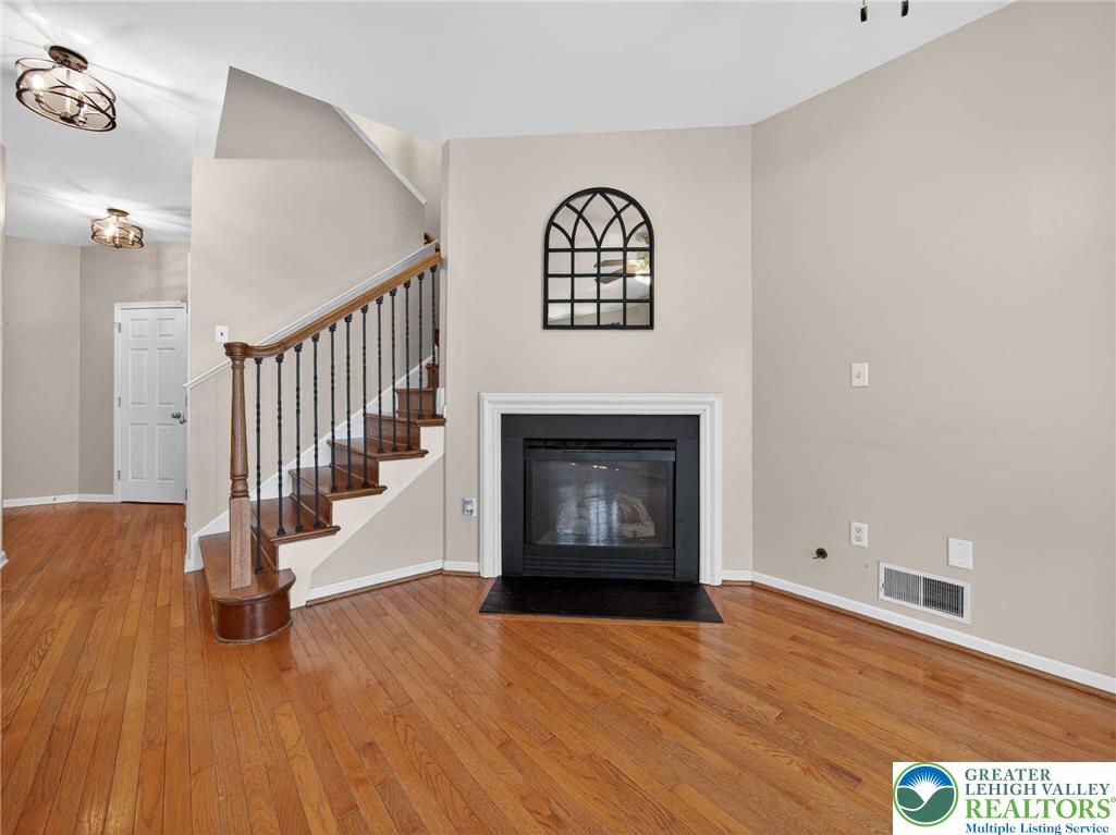 4312 Creek Road Allentown, PA 18104 - Photo 12 of 67 a view of an empty room with wooden floor and a fireplace