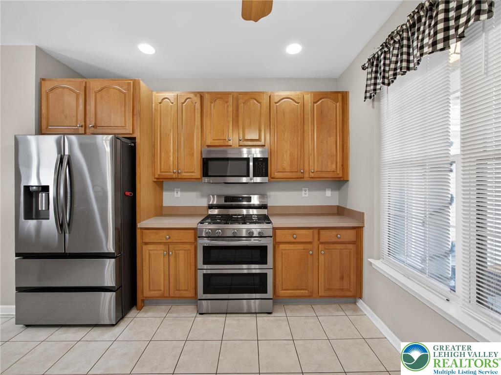 4312 Creek Road Allentown, PA 18104 - Photo 23 of 67 a kitchen with granite countertop a refrigerator and a stove