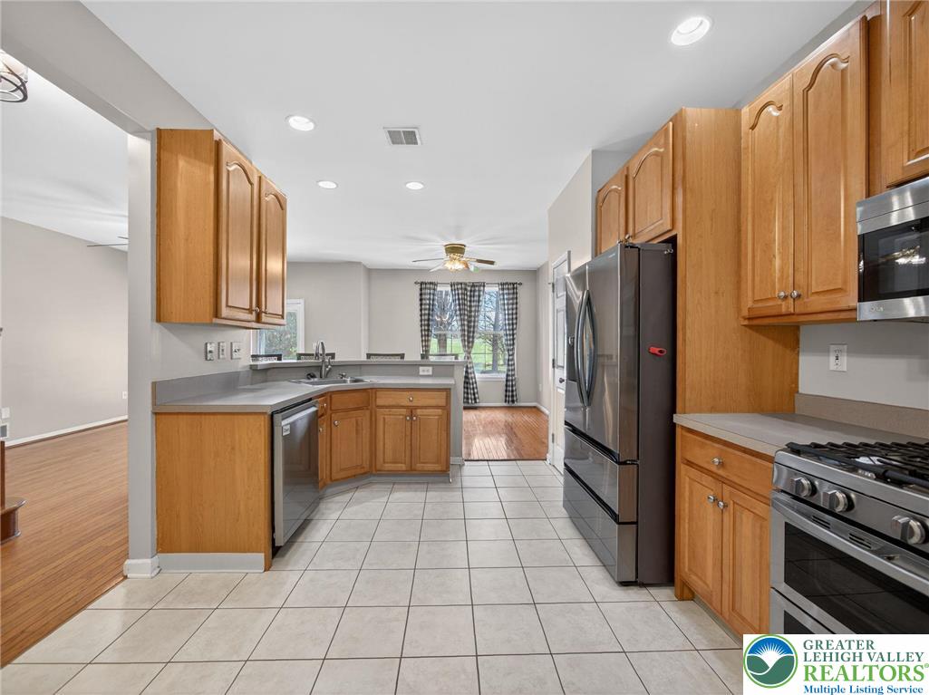 4312 Creek Road Allentown, PA 18104 - Photo 28 of 67 a kitchen with stainless steel appliances granite countertop a refrigerator and a stove
