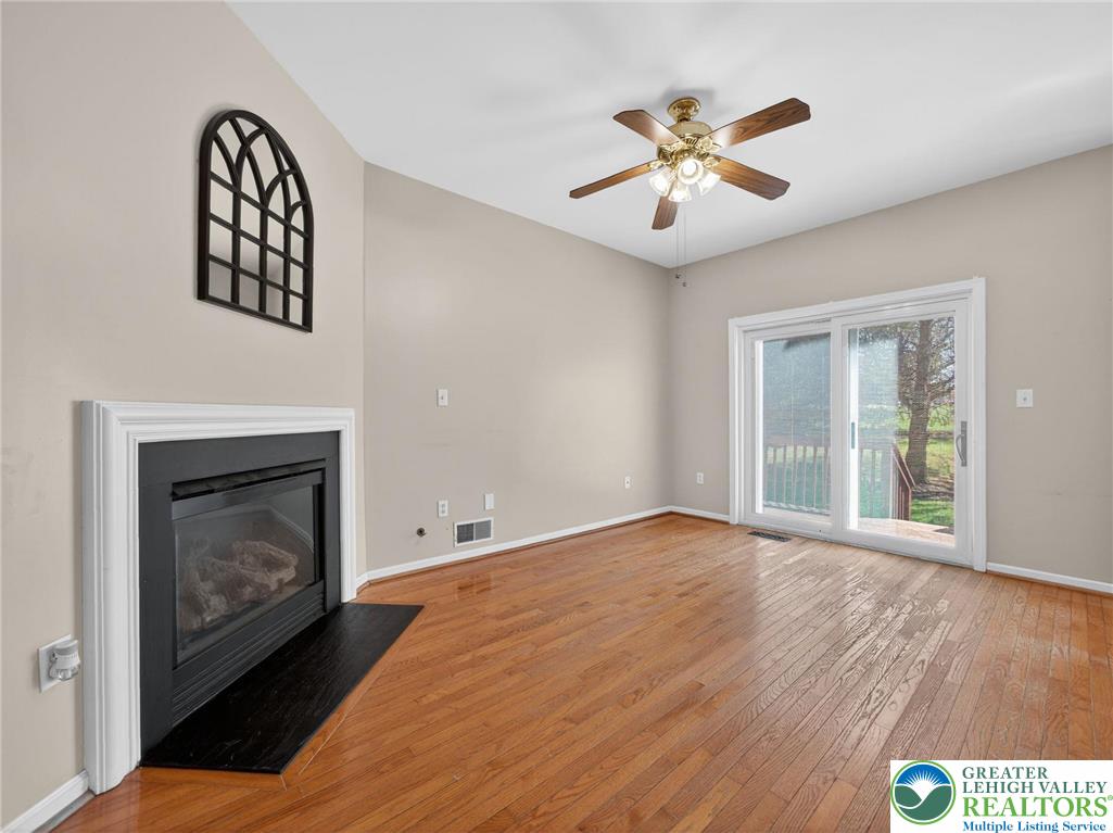 4312 Creek Road Allentown, PA 18104 - Photo 10 of 67 a view of an empty room with wooden floor and a fireplace