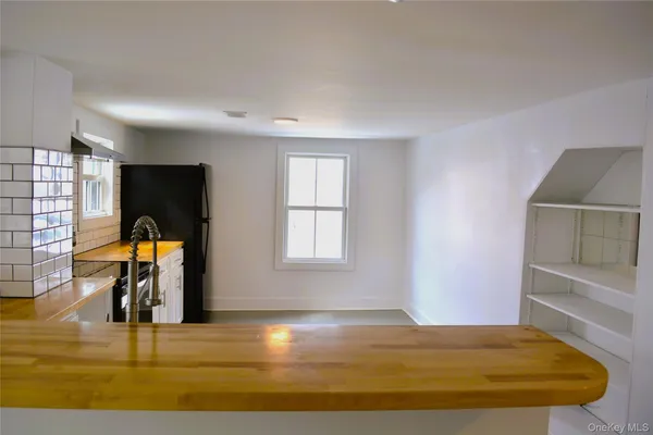 a view of a livingroom with workspace and a window