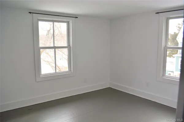 a bedroom with bed and glass door