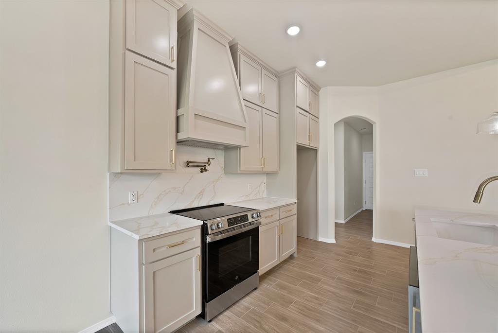 501 Harris Road Azle, TX 76020 - Photo 10 of 29 a kitchen with stainless steel appliances granite countertop a stove a refrigerator and a sink