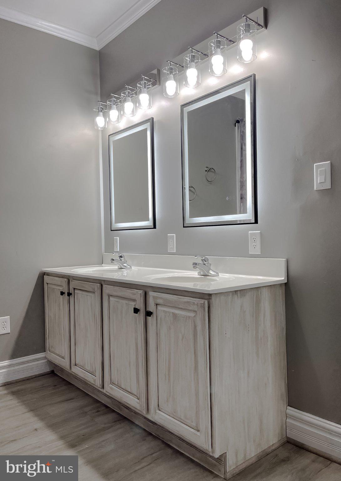 400 Adelina Road Prince Frederick, MD 20678 - Photo 26 of 57 Elegant dual-sink vanity with mirrors.