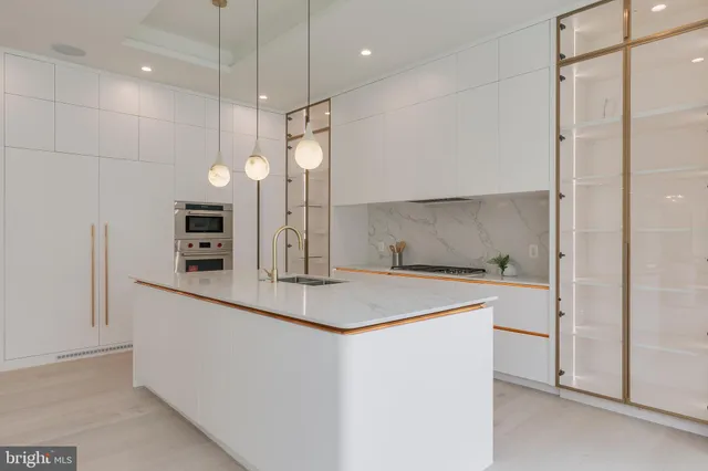 a kitchen with a sink a counter space and stainless steel appliances