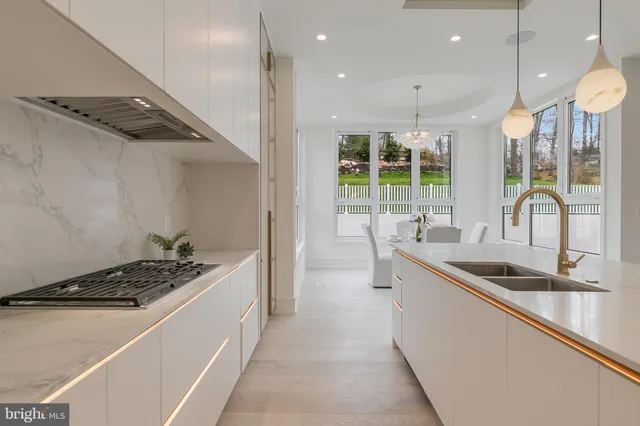 a kitchen with sink a stove and a refrigerator