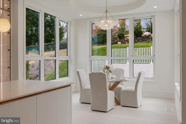 a dining room with furniture large windows and outdoor view
