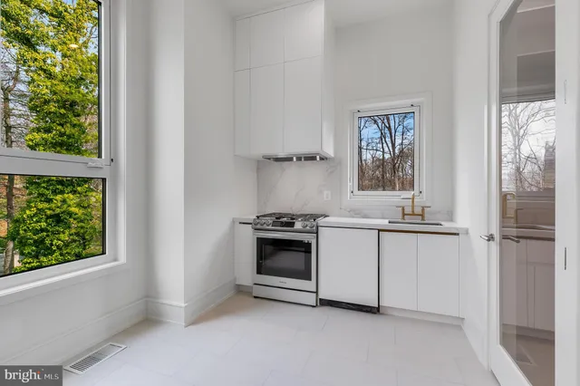 a kitchen with a stove and a refrigerator