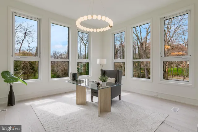 a work room with furniture and a large window