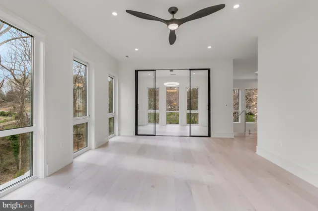 a view of an empty room with a fireplace and a window