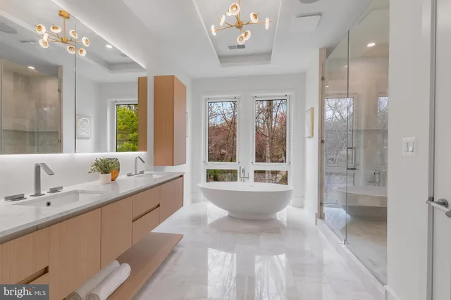 a large bathroom with a large tub shower and sink