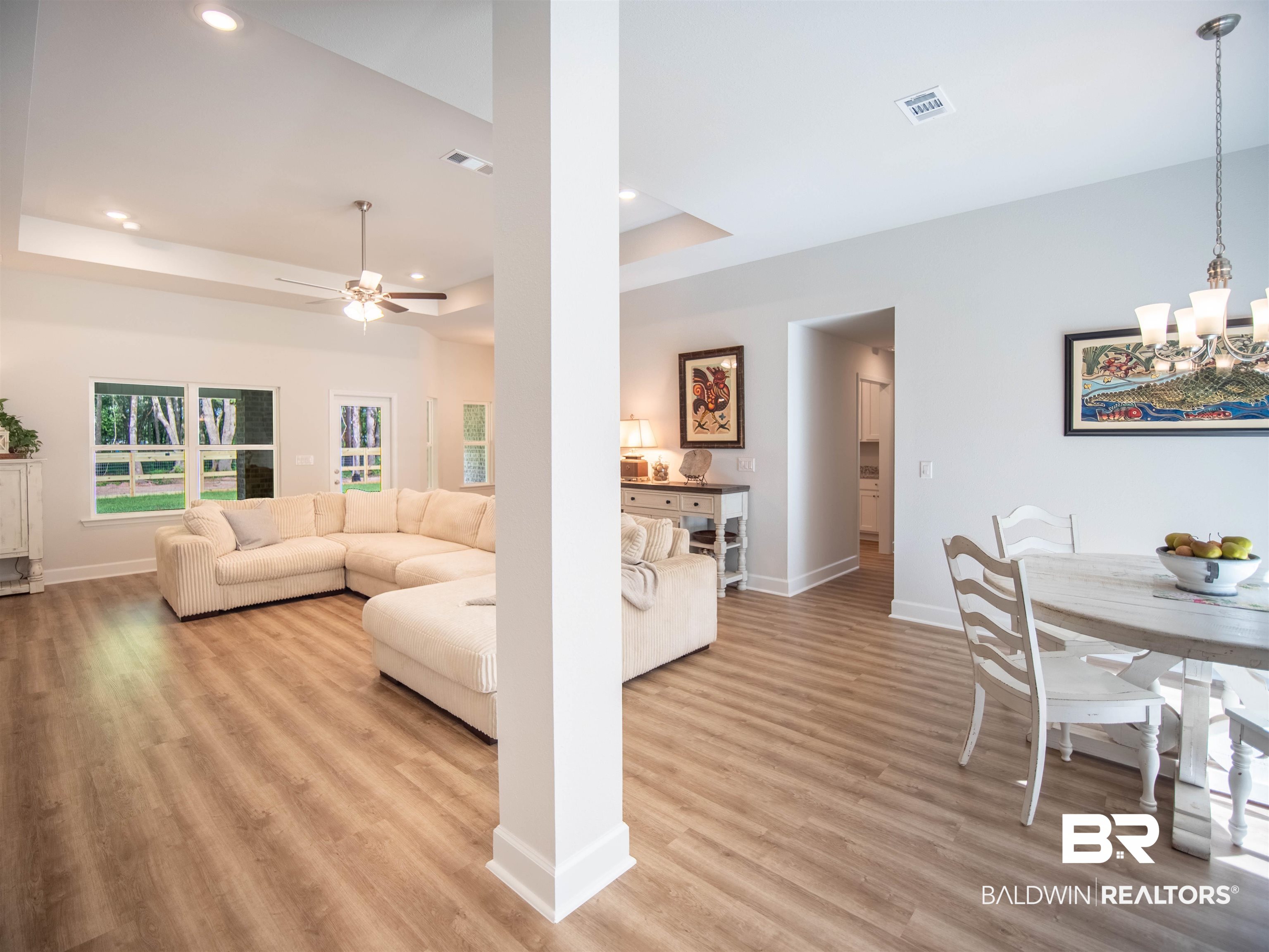 12646 Michigan Avenue Elberta, AL 36530 - Photo 4 of 47 Living room featuring light wood-style flooring, recessed lighting, ceiling fan, a chandelier, and a tray ceiling
