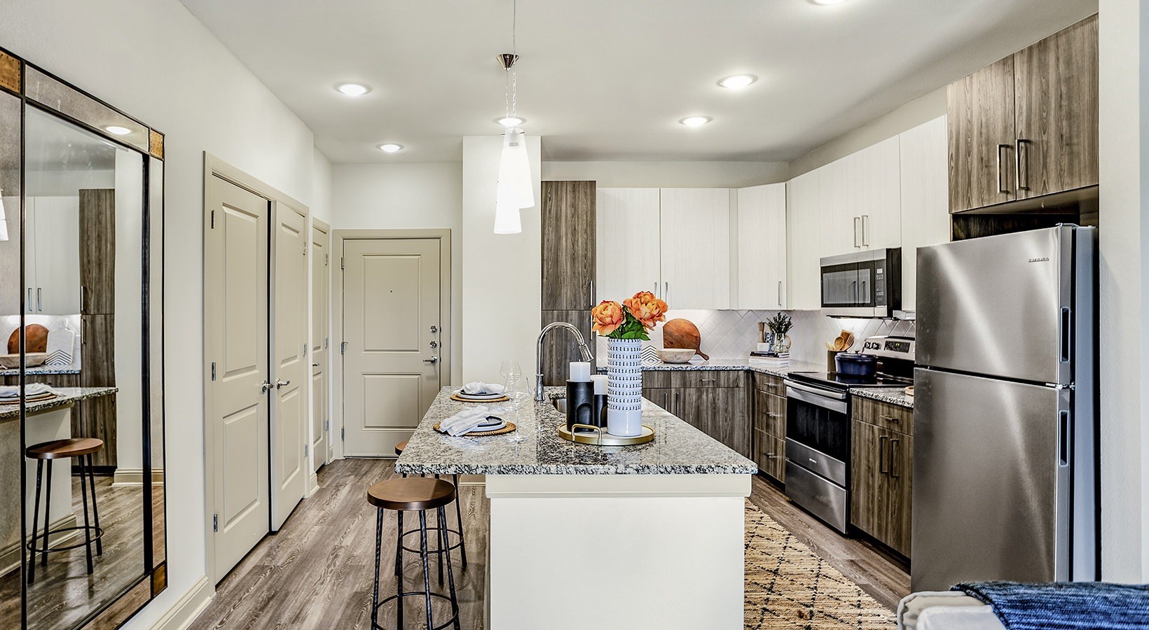 7100 Uvalde Road, Unit 9301 Houston, TX 77049 - Photo 7 of 28 a kitchen with stainless steel appliances a refrigerator and a stove top oven