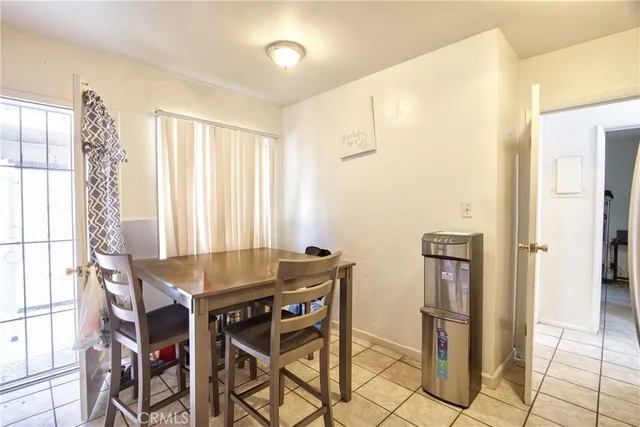 a dining room with furniture and window