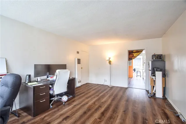 a view of a workspace with furniture and wooden floor