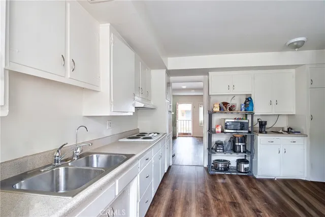 a kitchen with kitchen island a sink stove and cabinets