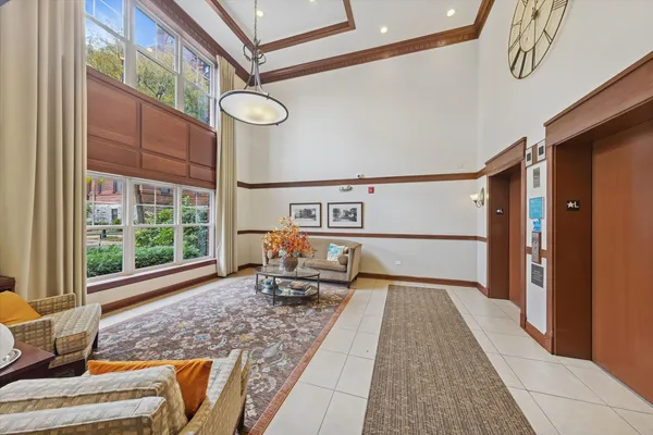 a very nice looking room with a large window and chandelier