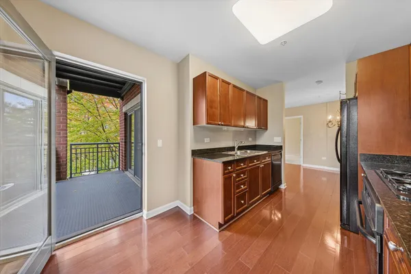 a kitchen with stainless steel appliances granite countertop a refrigerator and a stove