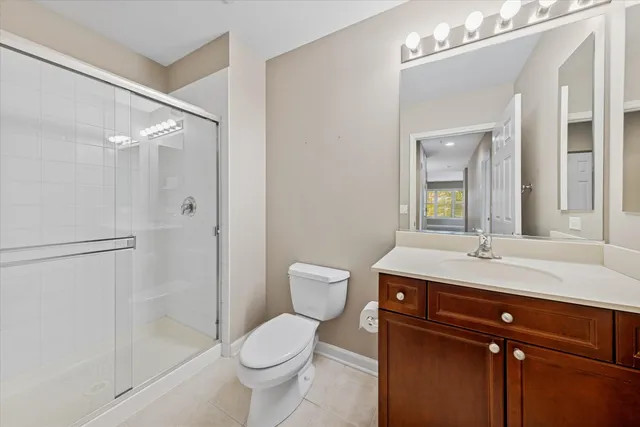 a bathroom with a granite countertop sink toilet a mirror and shower