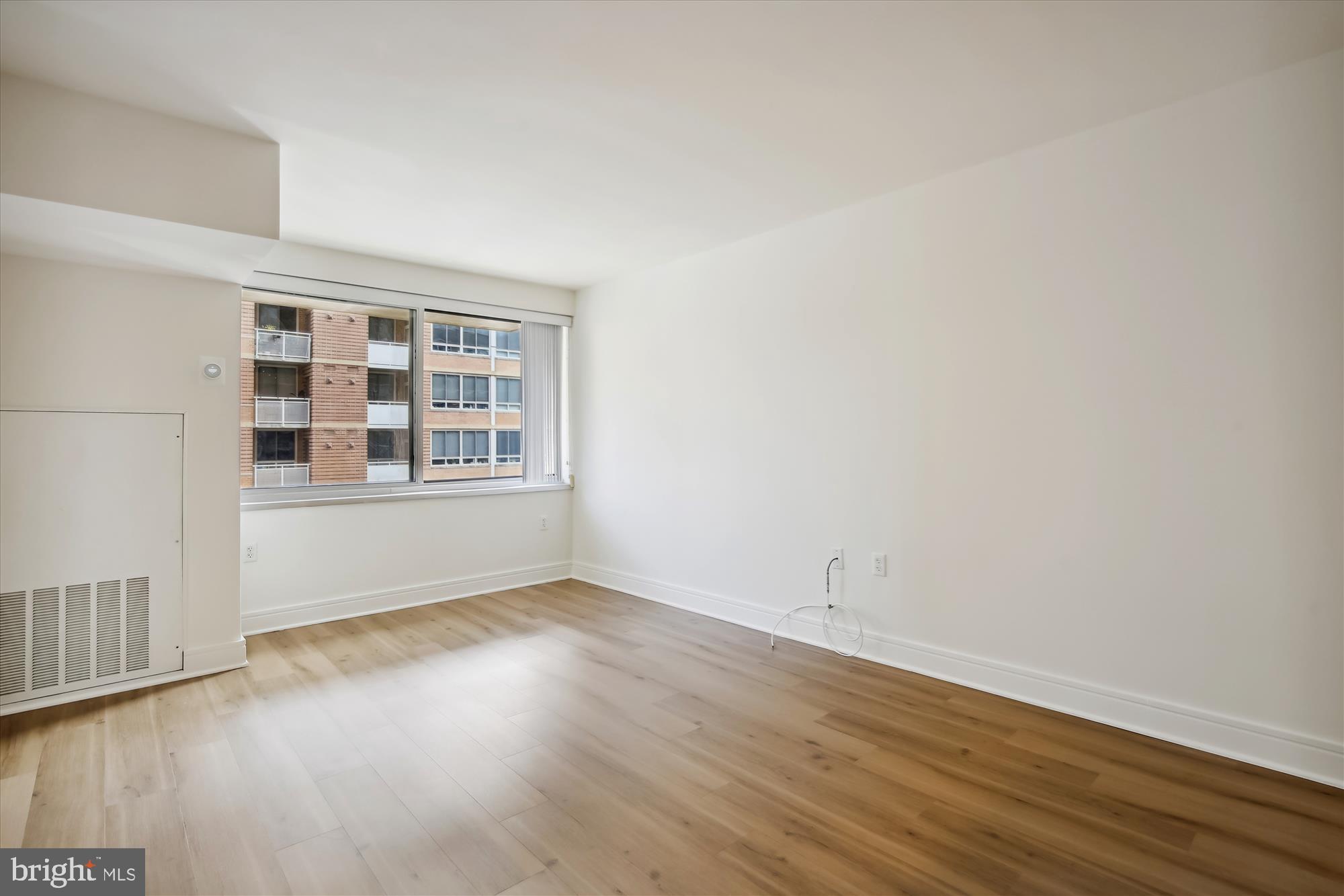 800 4th Street Southwest, Unit S113 Washington, DC 20024 - Photo 12 of 37 a view of an empty room with wooden floor and windows