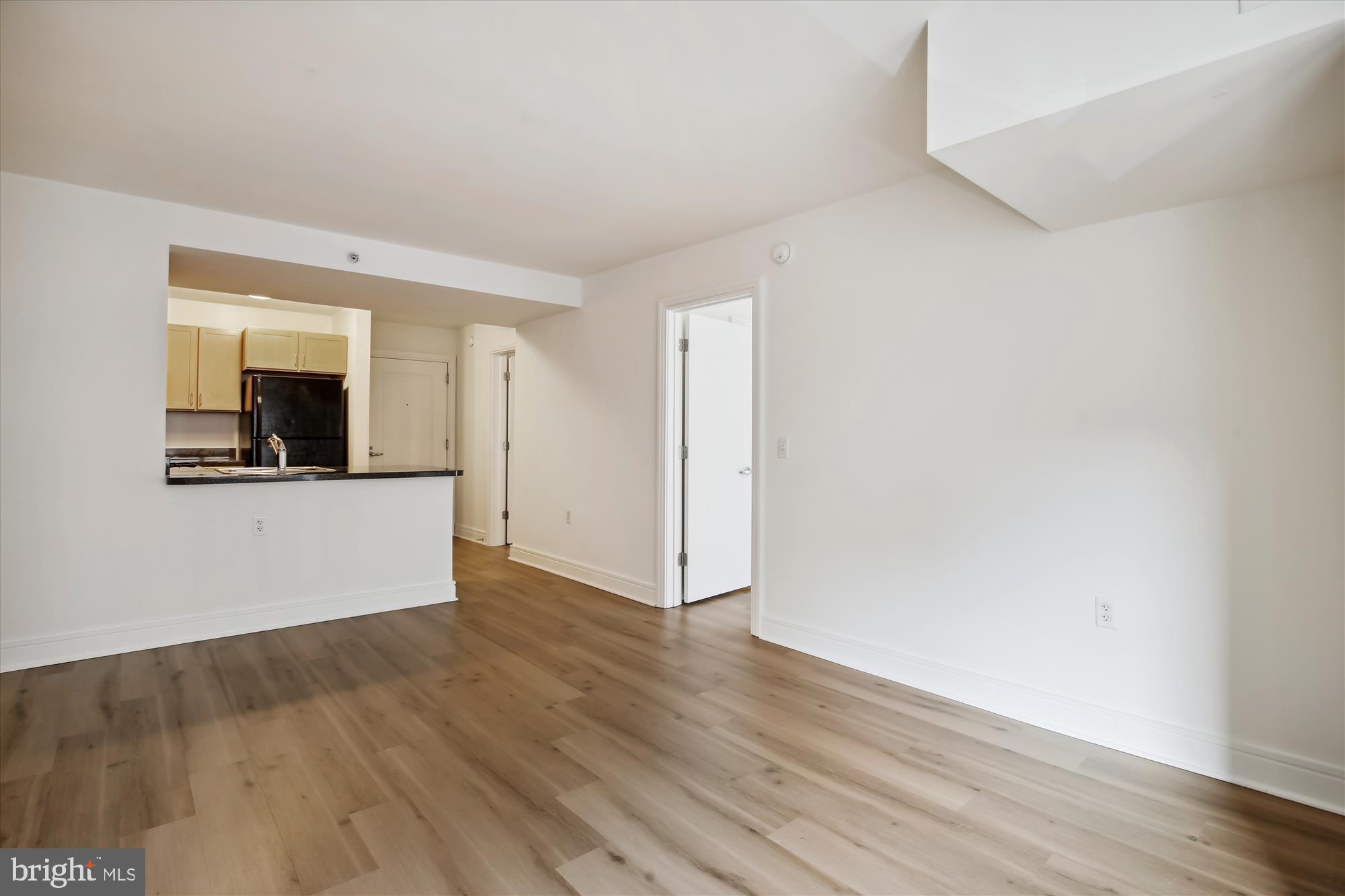 800 4th Street Southwest, Unit S113 Washington, DC 20024 - Photo 14 of 37 an empty room with wooden floor and mirror