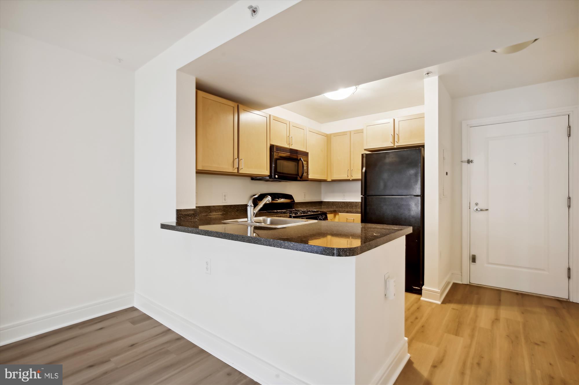 800 4th Street Southwest, Unit S113 Washington, DC 20024 - Photo 4 of 37 a kitchen with stainless steel appliances granite countertop a sink stove and refrigerator