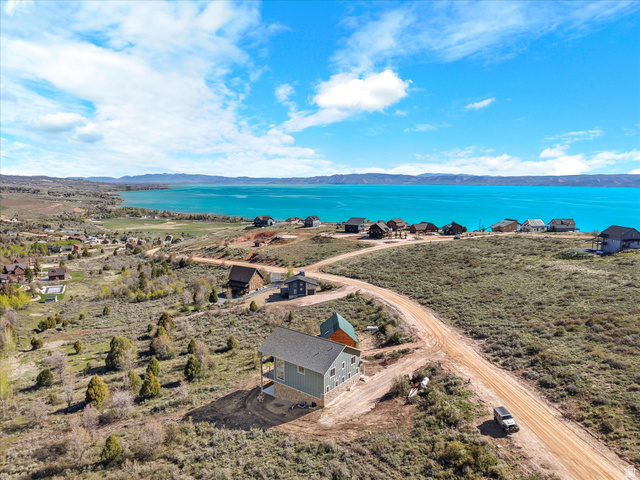 1159 North Broad Hollow Road Garden City, UT 84028 - Photo 20 of 55 Aerial perspective showcasing a property with a light blue exterior and dark gray roof