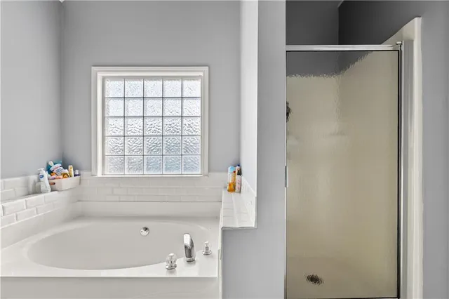 a bathroom with a bathtub and a window