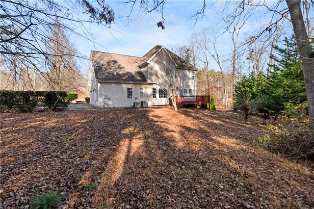 a view of a house with a large tree in front of it