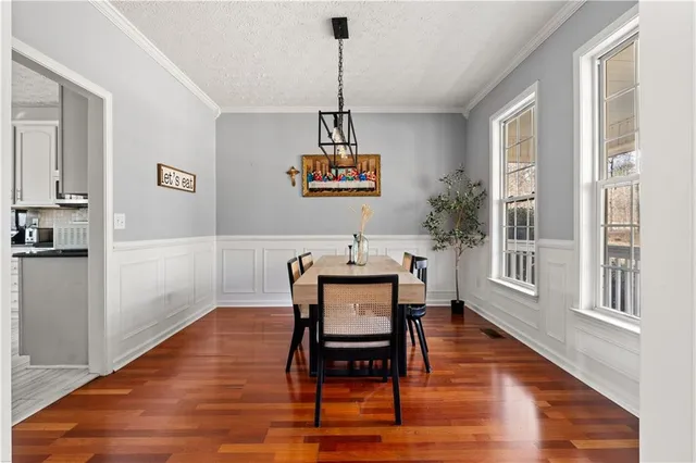 a view of a room with furniture wooden floor and windows