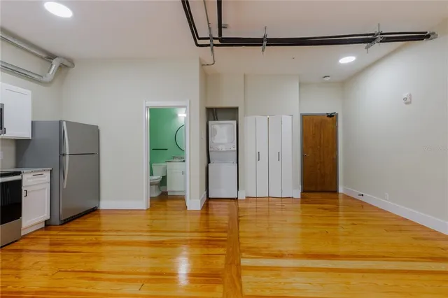 a view of empty room with wooden floor
