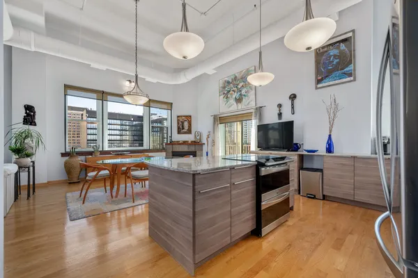 a kitchen with stainless steel appliances granite countertop a stove and a refrigerator