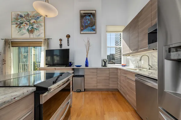 a kitchen with stainless steel appliances a stove sink and microwave