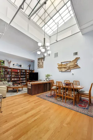 a living room with lots of furniture and chandelier